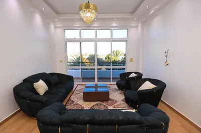 a living room with two couches and a table at Pearl of Luxor on the Nile -Apartment in Luxor