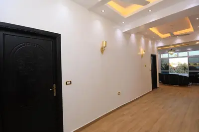 a room with a black door and a white wall at Pearl of Luxor on the Nile -Apartment in Luxor