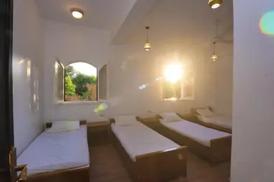 a room with two beds and two windows at Pearl of Luxor on the Nile -Apartment in Luxor
