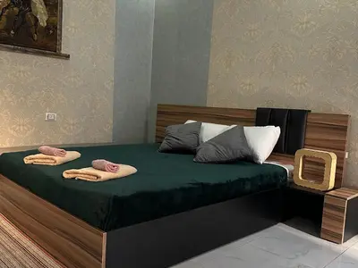 a bedroom with a bed with two towels on it at Horizon on Mamsha in Hurghada