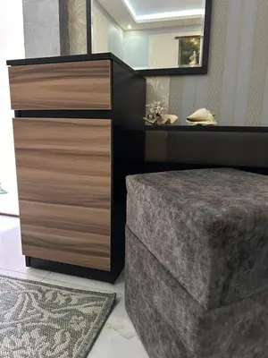 a bedroom with a bed and a dresser and a mirror at Horizon on Mamsha in Hurghada