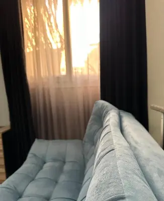 a couch in front of a window with curtains at Horizon on Mamsha in Hurghada