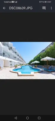 a picture of a swimming pool with umbrellas at Captain Beach Resort Suite in Hurghada