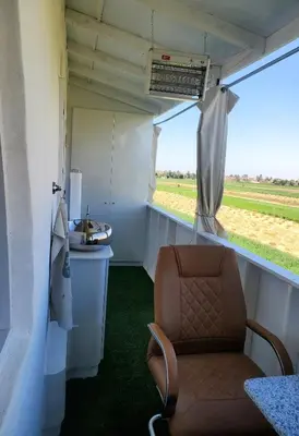 a chair in a train room with a window at Casa Helvetica in Luxor