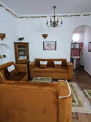 a living room with couches and a chandelier at Casa Helvetica in Luxor
