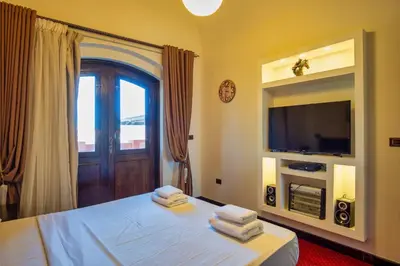 a bedroom with a bed with a television and towels at Wast golf Y 41 in Hurghada