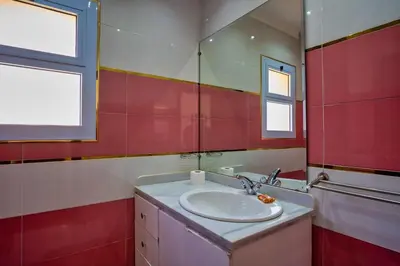 a bathroom with a sink and a mirror at Wast golf Y 41 in Hurghada