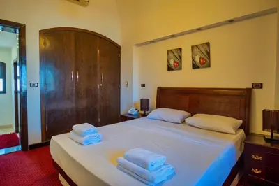 a bedroom with a bed with towels on it at Wast golf Y 41 in Hurghada