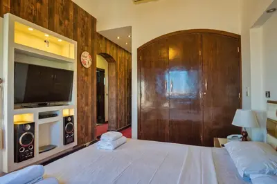 a bedroom with a large bed and a tv at Wast golf Y 41 in Hurghada