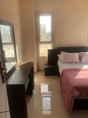 a bedroom with a bed and a desk and a window at Egypt Traveler Hotel in Hurghada