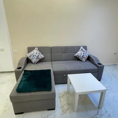 a living room with a couch and a table at منتجع جوليانا بيتش ريزورت in Hurghada