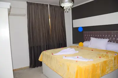 a bedroom with a large bed with towels on it at Luxe Apartment Inside Karma Beach Resort Al Ahiaa-Beach Free Access in Hurghada
