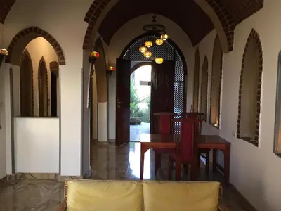a hallway with a table and chairs in a building at Garden view guest house in Luxor
