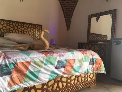 a bedroom with a bed with a snake on it at Garden view guest house in Luxor