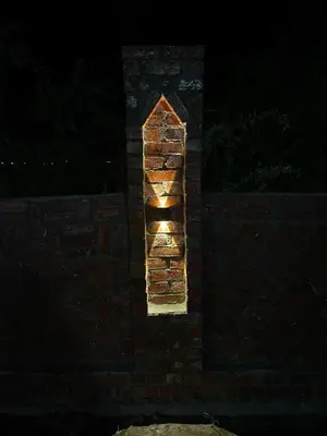 a brick wall with a light on it at night at Julia House in Luxor