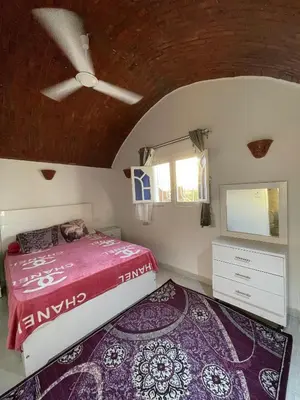 a bedroom with a bed and a tv on a ceiling at Julia House in Luxor