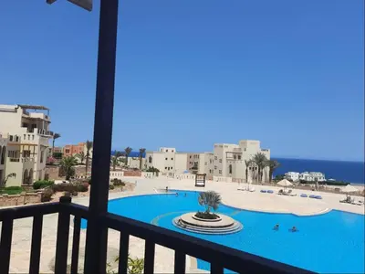 a view of a swimming pool from a balcony at Designer Loft mit grandiosem Meerblick am roten Meer in Hurghada