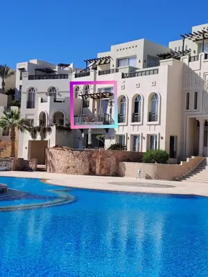 a house with a swimming pool in front of a building at Designer Loft mit grandiosem Meerblick am roten Meer in Hurghada