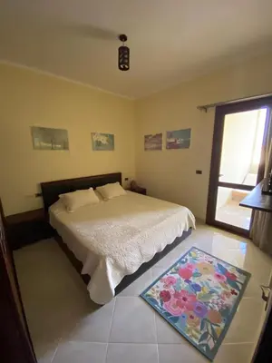 a bedroom with a bed and a rug on the floor at Gravity Beach Apartment Non Egyptians only in Hurghada