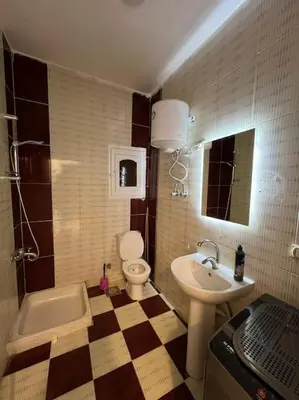 a bathroom with a toilet and a sink at Spacious 2-Bedroom Apartment - Families Only in Hurghada