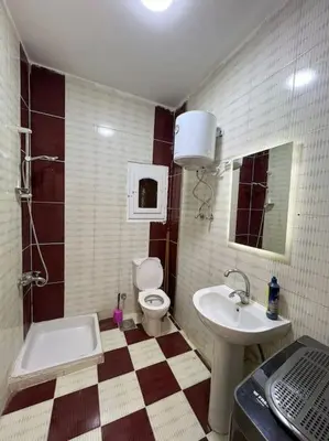 a bathroom with a sink and a toilet and a sink at Spacious 2-Bedroom Apartment - Families Only in Hurghada