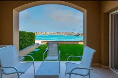 a patio with chairs and a view of the beach at El-Gouna Water-Side Apartment in Hurghada