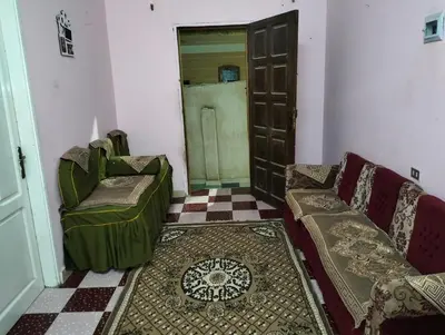 a living room with two couches and a door at مدينة القصير in Quseir