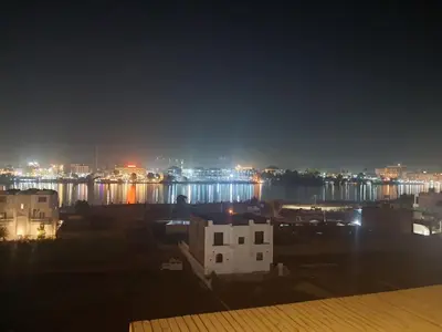 a view of a city at night with a river at Nile Ruby Luxor in Luxor