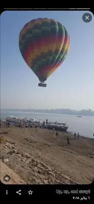 a hot air balloon flying over a beach at Nile Ruby Luxor in Luxor