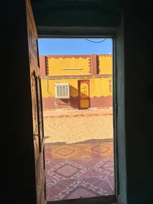 an open door with a view of a building at Bafana Bafana Nubian Hostel in Najâ€˜ al MadÄbb