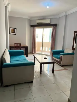 a living room with two couches and a coffee table at H&H Dream in Hurghada