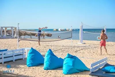two people playing a game of volley ball on the beach at Comfort Marine in Hurghada