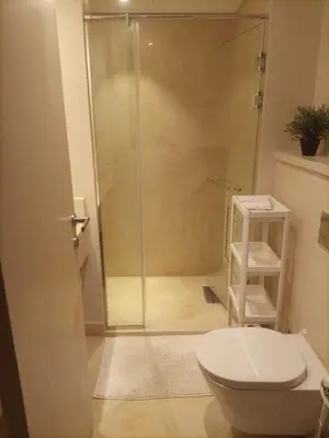 a bathroom with a glass shower with a toilet at Mangroovy retreat in Hurghada