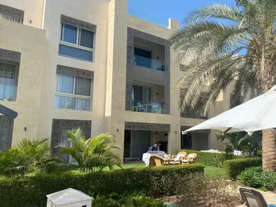 a building with a table and chairs in front of it at Mangroovy retreat in Hurghada