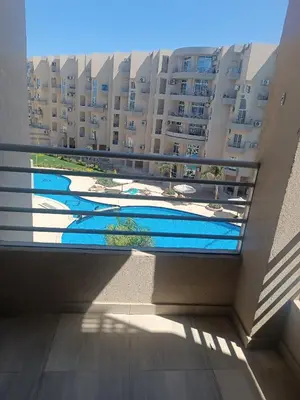 a view from the balcony of a building with swimming pools at Princess resort flat no217 in Hurghada