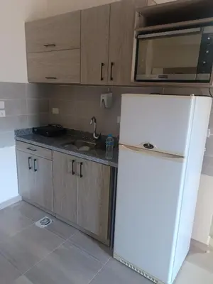 a kitchen with a white refrigerator and a microwave at Princess resort flat no217 in Hurghada