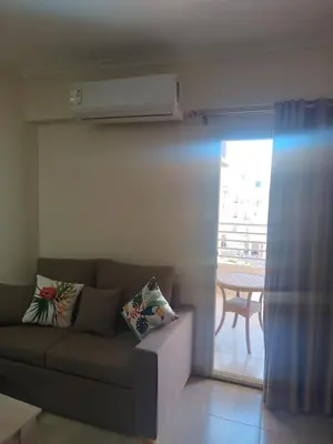 a living room with a couch and a balcony at Princess resort flat no217 in Hurghada