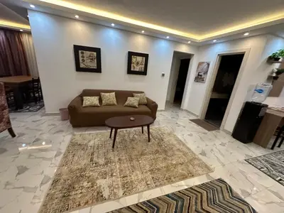 a living room with a couch and a table at Fanadir Bay in Hurghada