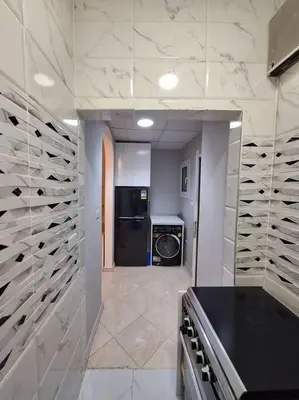 a kitchen with a counter and a dishwasher at Hurghada Flat in Hurghada