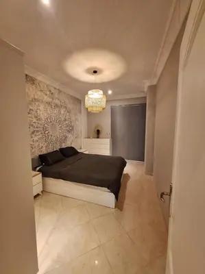 a bedroom with a bed in the middle of a room at Hurghada Flat in Hurghada