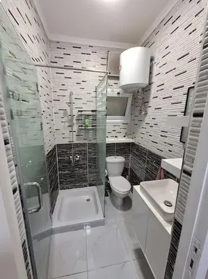 a bathroom with a shower and a toilet and a sink at Hurghada Flat in Hurghada