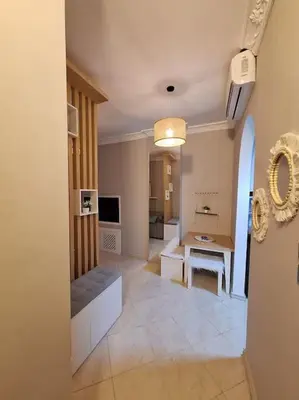 a living room with a hallway with a table at Hurghada Flat in Hurghada