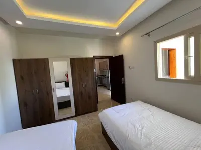 a bedroom with a white bed and a window at Elegant 2-Bedroom Suite Mirage Bay in Hurghada