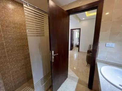 a bathroom with a shower and a toilet and a sink at Elegant 2-Bedroom Suite Mirage Bay in Hurghada