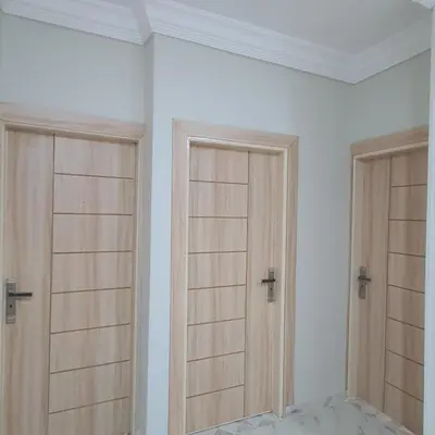a room with two wooden doors on a wall at Lareen's apartment in Quseir