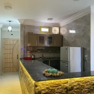 a kitchen with a counter top with a refrigerator at Lareen's apartment in Quseir