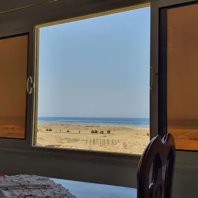 a room with a window with a view of the desert at Lareen's apartment in Quseir