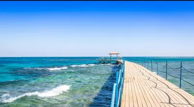 a wooden pier stretches out into the ocean at Chalet in mirage resort bay resort & aqua park in Hurghada