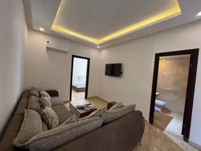 a living room with a couch and a mirror at Chalet in mirage resort bay resort & aqua park in Hurghada
