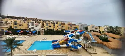 a pool with a water slide and a water park at Fanadir Bay Hurghada in Hurghada
